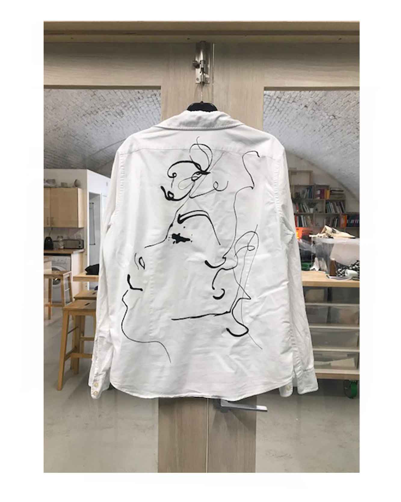 Line illustration of a women's profile embroidered onto a vintage oversized shirt.