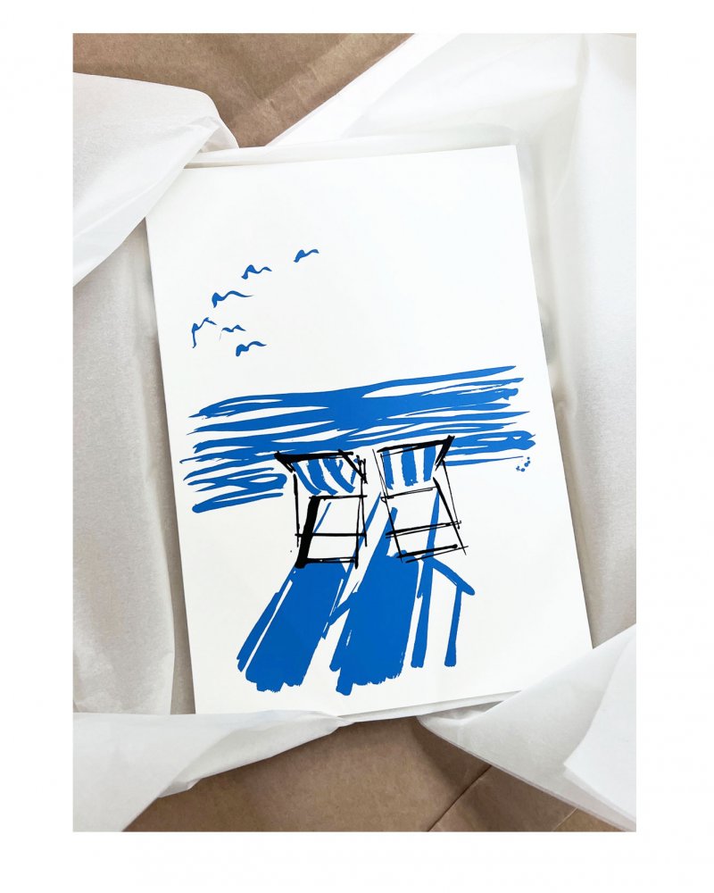 Inspired by Summer on the coast. Two striped deckchairs - looking out at the horizon from the beach. Two colour silkscreen print. Blue and black silkscreen print. Striped deckchairs on the beach. Perfect for beach lovers.