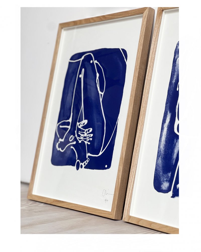 Summer Blues Side view framed. One colour silkscreen print inspired by Summer skies and sunbathing - for those who follow the Sun. Fine art print of an original illustration by Caroline Tomlinson.