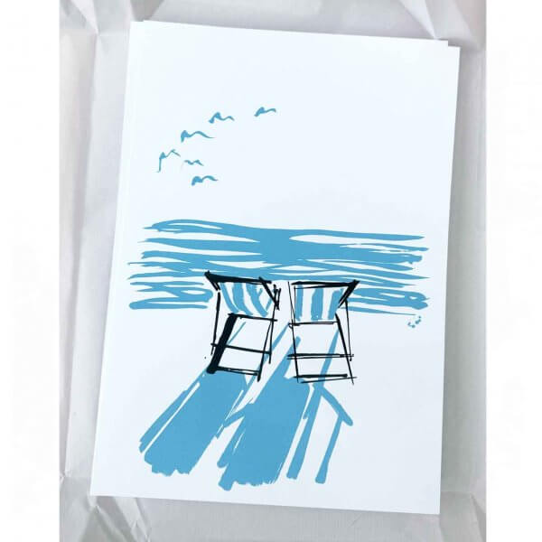 Inspired by Summer on the coast. A re-edition in a new colour way of a popular sold out first edition. Two striped deckchairs - looking out at the horizon from the beach. Two colour silkscreen print. Blue and black silkscreen print. Striped deckchairs on the beach. Perfect for beach lovers.