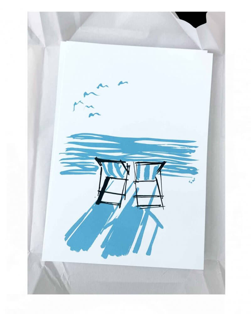 Inspired by Summer on the coast. A re-edition in a new colour way of a popular sold out first edition. Two striped deckchairs - looking out at the horizon from the beach. Two colour silkscreen print. Blue and black silkscreen print. Striped deckchairs on the beach. Perfect for beach lovers.