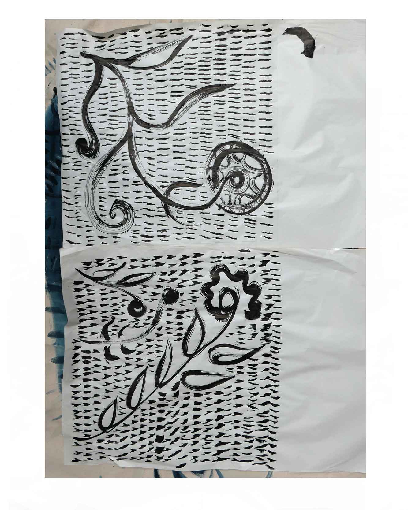 Initial ink drawings for floral woven textile designs inspired by wild flowers on an artist desk.