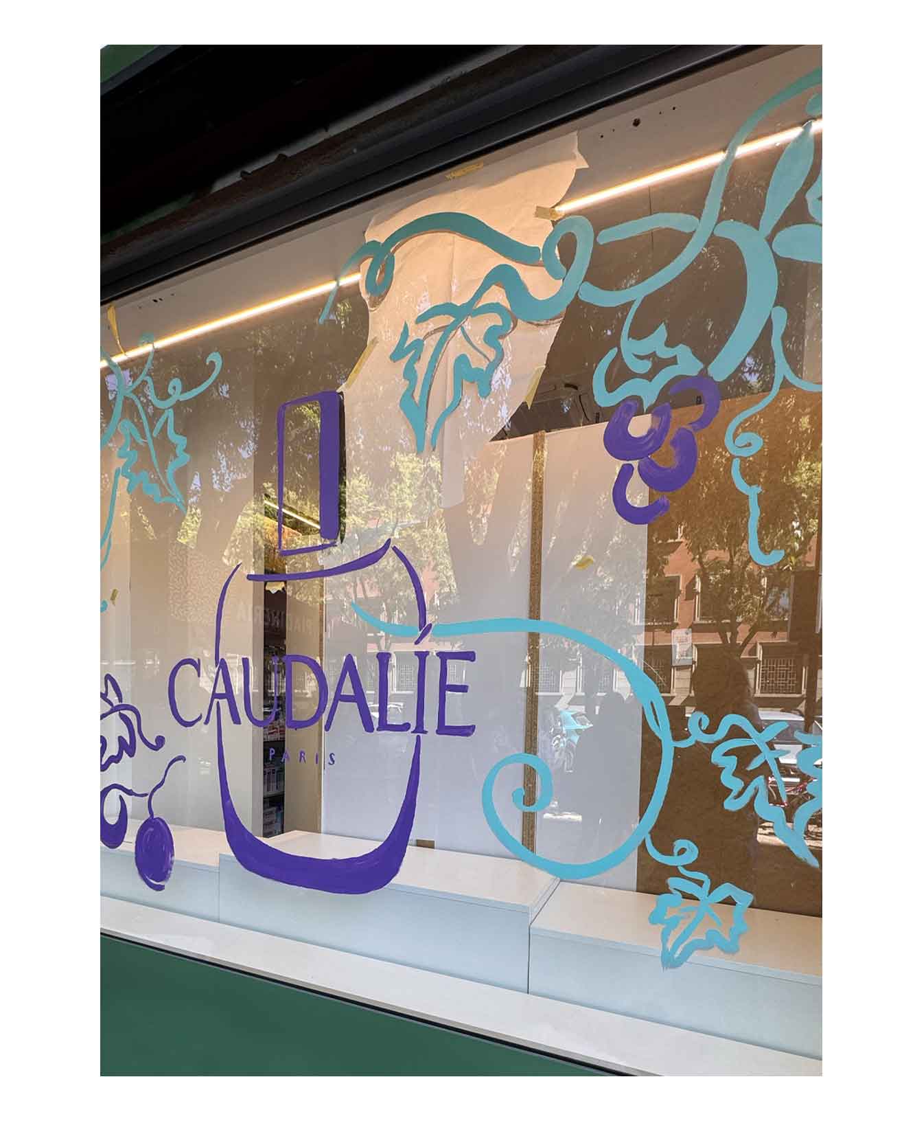 Artist live painting gestural botanical illustrations on large storefront windows during Milan Design Week for a luxury beauty brand, featuring fluid ink lines inspired by nature and fragrance.