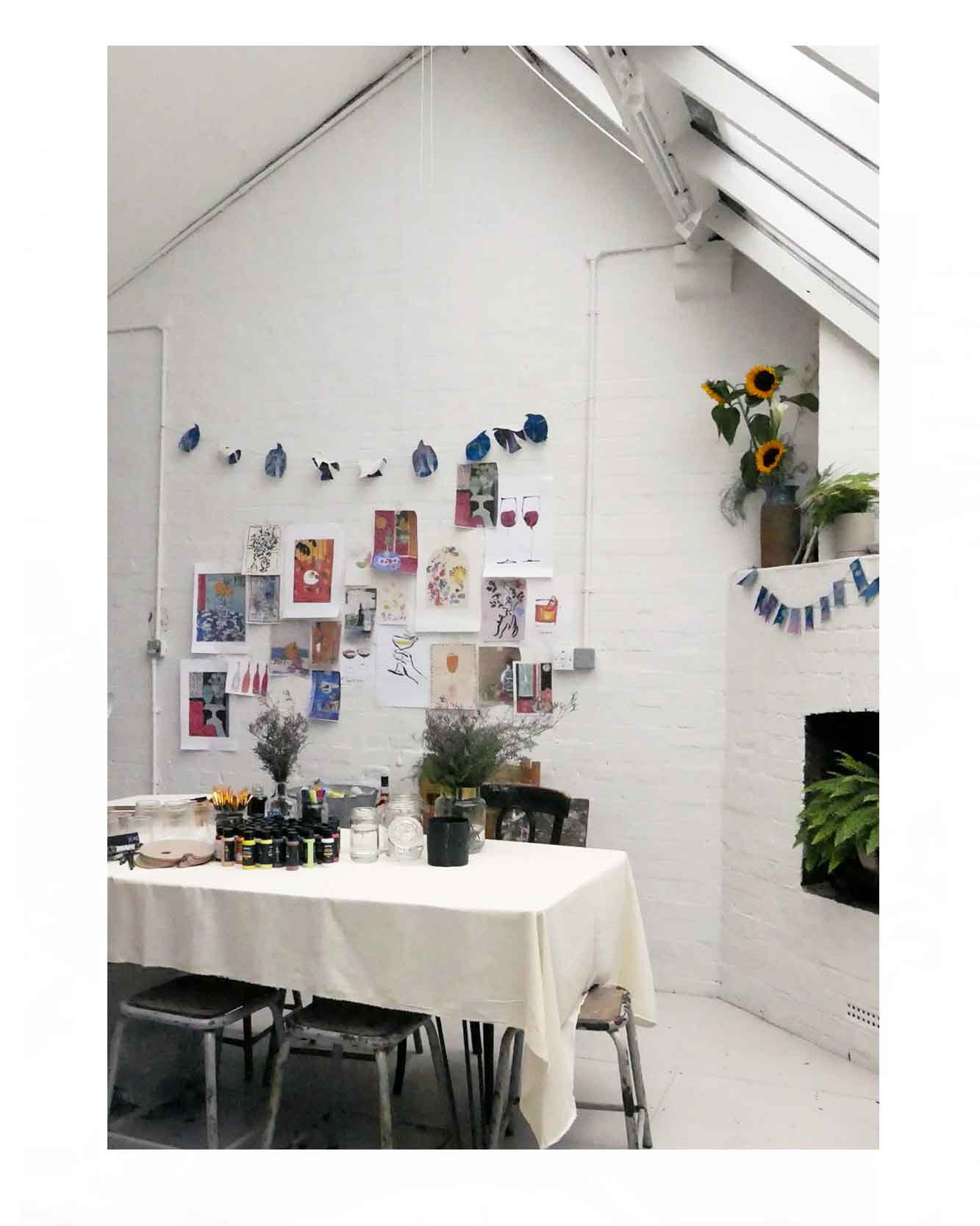 Photograph of creative workshop held  in illustrator and artists East London studio Caroline Tomlinson. The workshop was inspired by the artists love of travel and cocktails - with the theme "Five o'clock somewhere" 