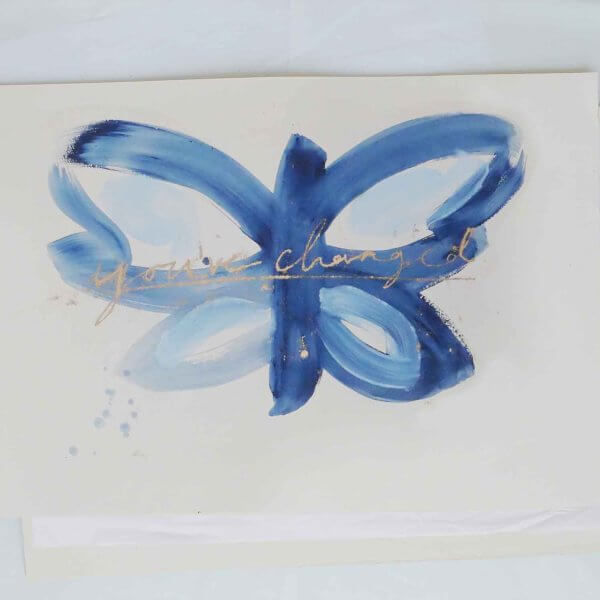 Blue brushstroke butterfly with taupe wing markings and handwritten "you've changed - out of the blue " in ultramarine, original art by Caroline Tomlinson