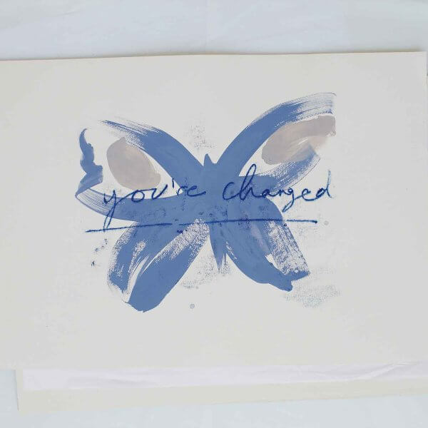 Blue brushstroke butterfly with taupe wing markings and handwritten "you've changed - new chapter" in ultramarine, original art by Caroline Tomlinson